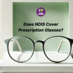 a pair of eyeglasses placed on a white platform against a light green background. Above the glasses, there is a circular logo with the text "I love ndis" where "love" is represented by a heart symbol. Below the logo, the text reads "Does NDIS Cover Prescription Glasses?" in black font. The setting has a modern and minimalist design with vertical lines on the sides.